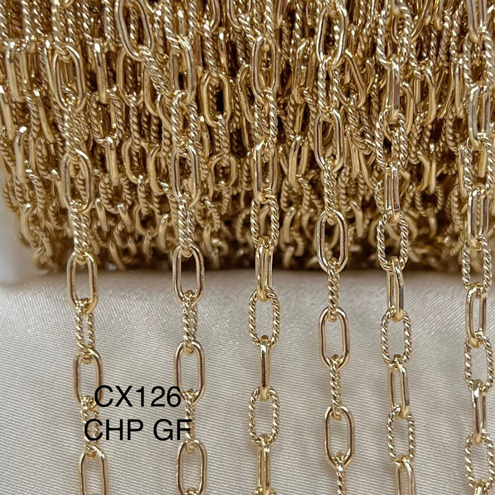 Gold paperclip chain on a white background with &
