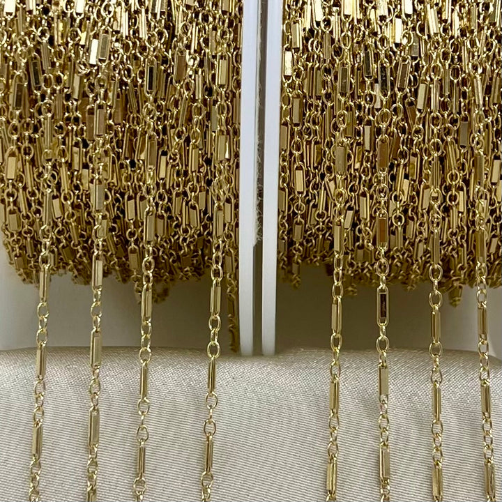 Close-up of gold chain fringe on a white background