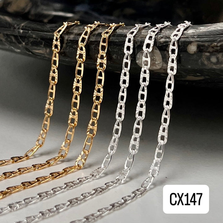 Gold and silver chain necklaces on a dark surface with &