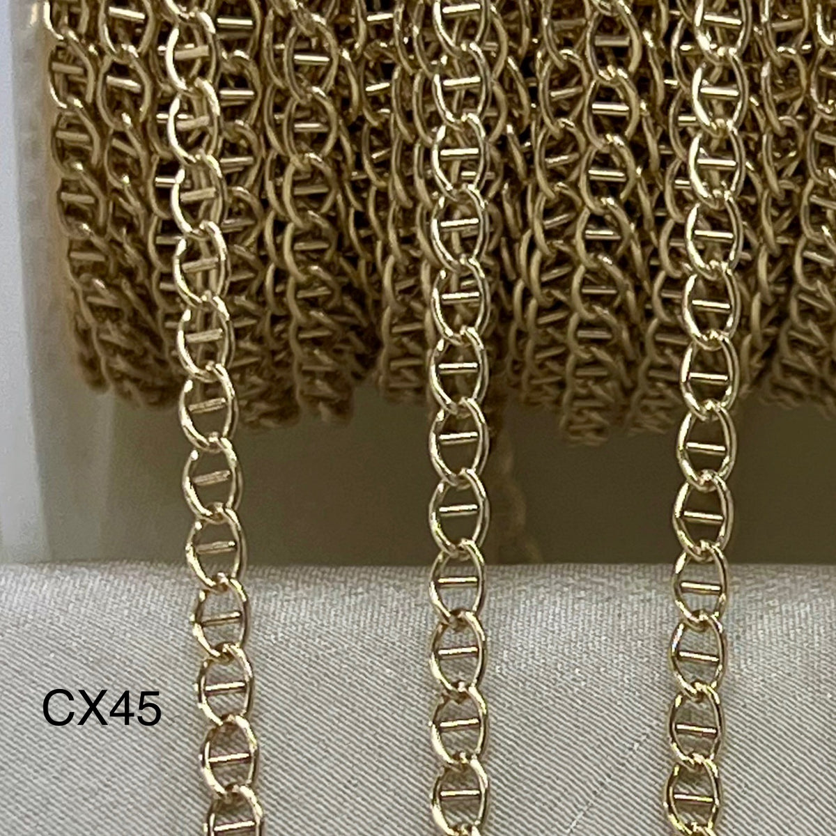 Gold Filled Mariner chain on a textured surface with 'CX45' label